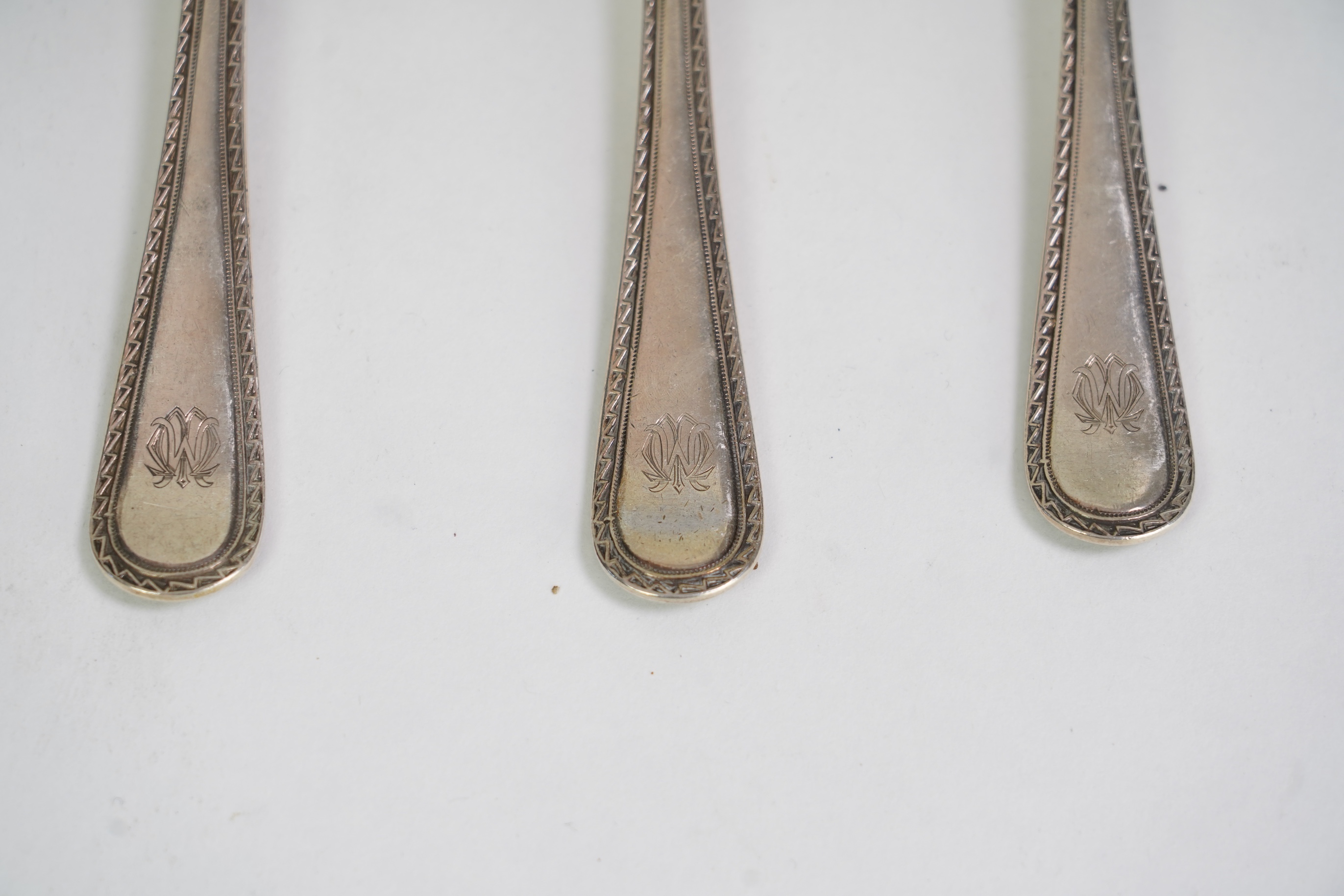 A set of six George V fancy Old English pattern table spoons by Elkington & Co, Birmingham, 1919, 22.2cm, together with a set of six fancy Hanoverian pattern table forks, Goldsmiths & Silversmiths Co Ltd, London, 1918, 3